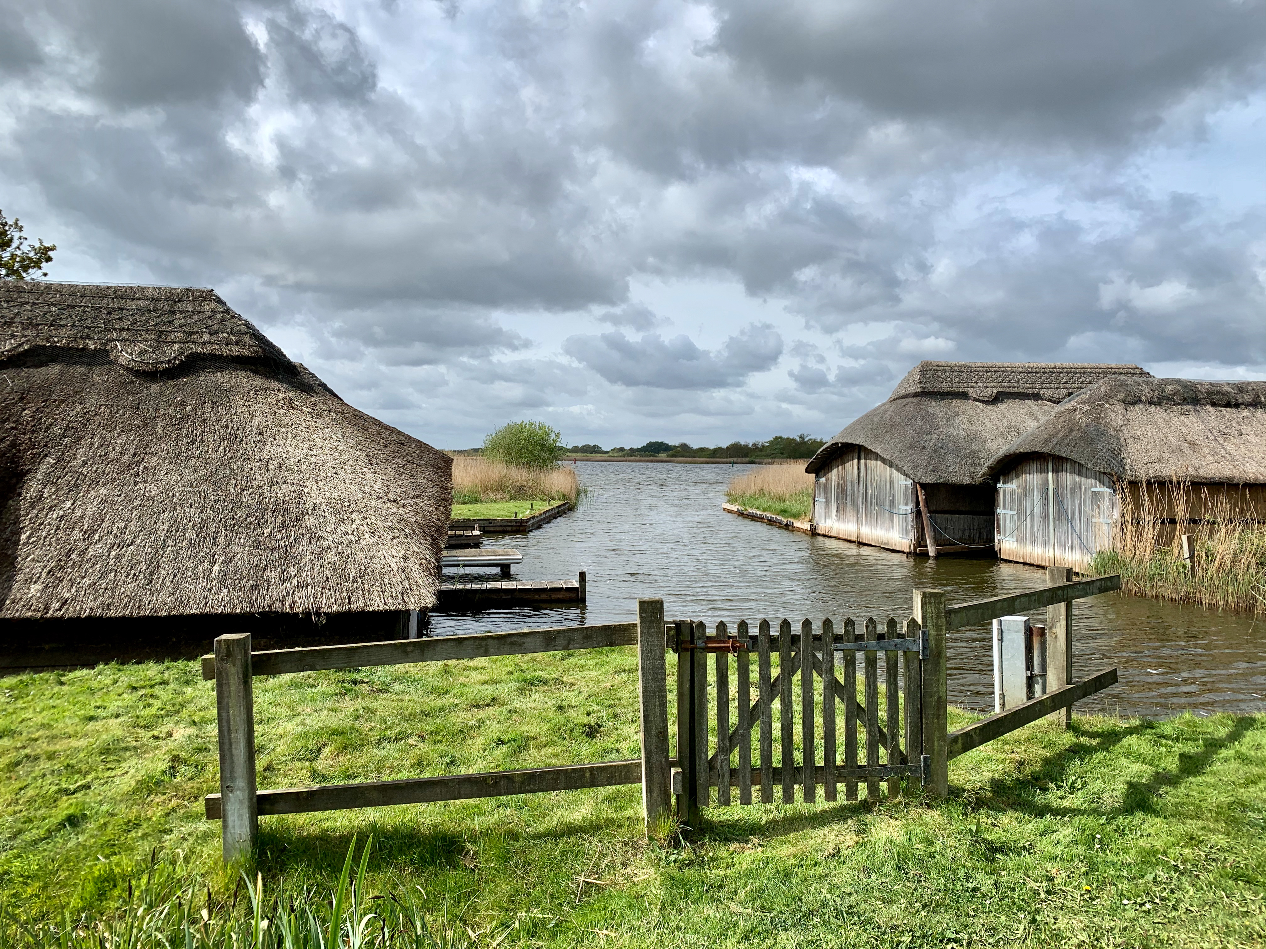 Hickling Village boat houses with straw roof on water